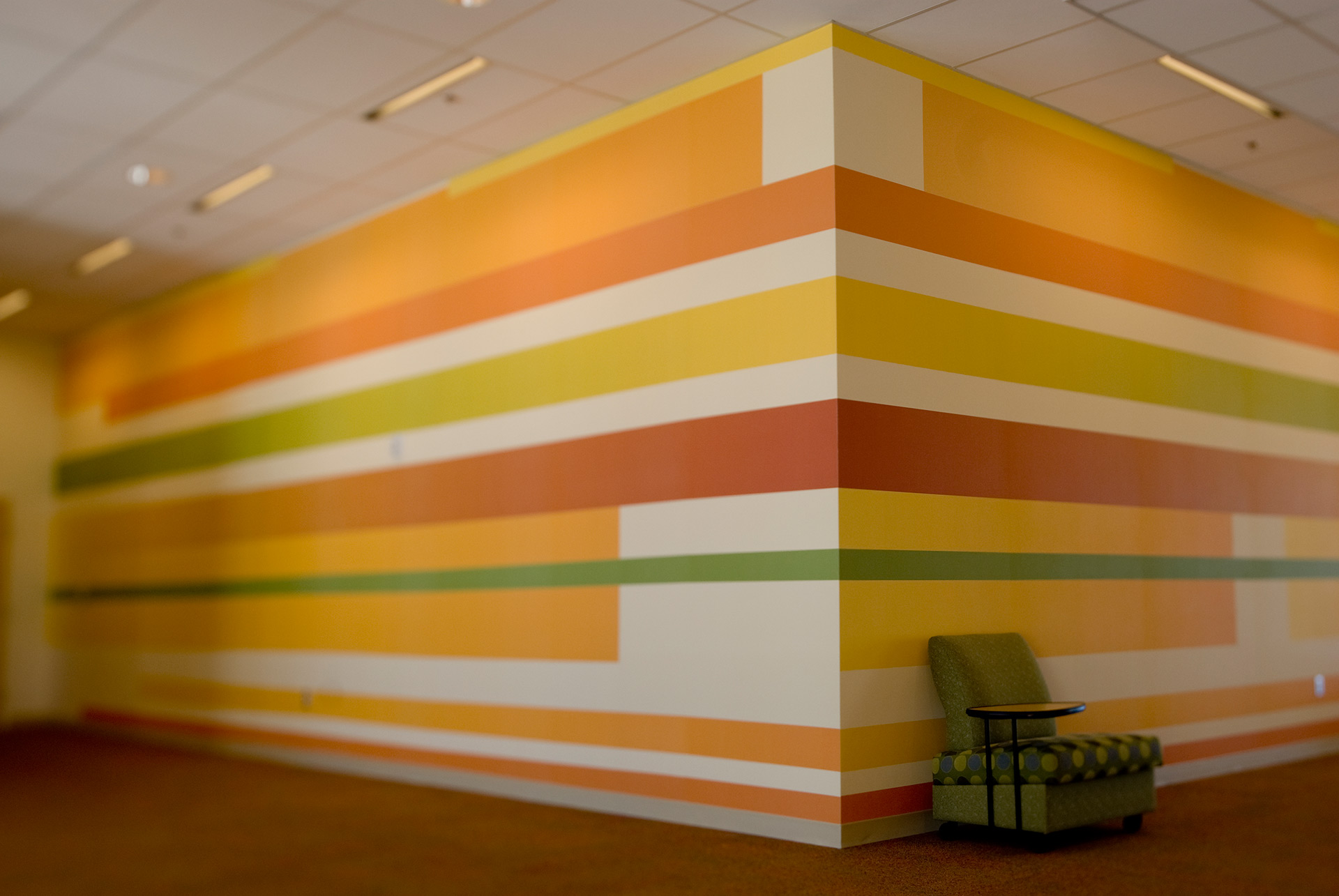 Corporate office stairwell with large branded environmental graphics and wall coverings