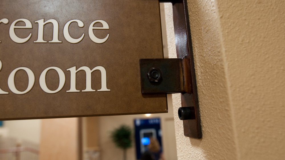 Close-up detail of decorative mounting bracket used for projecting healthcare wayfinding signs
