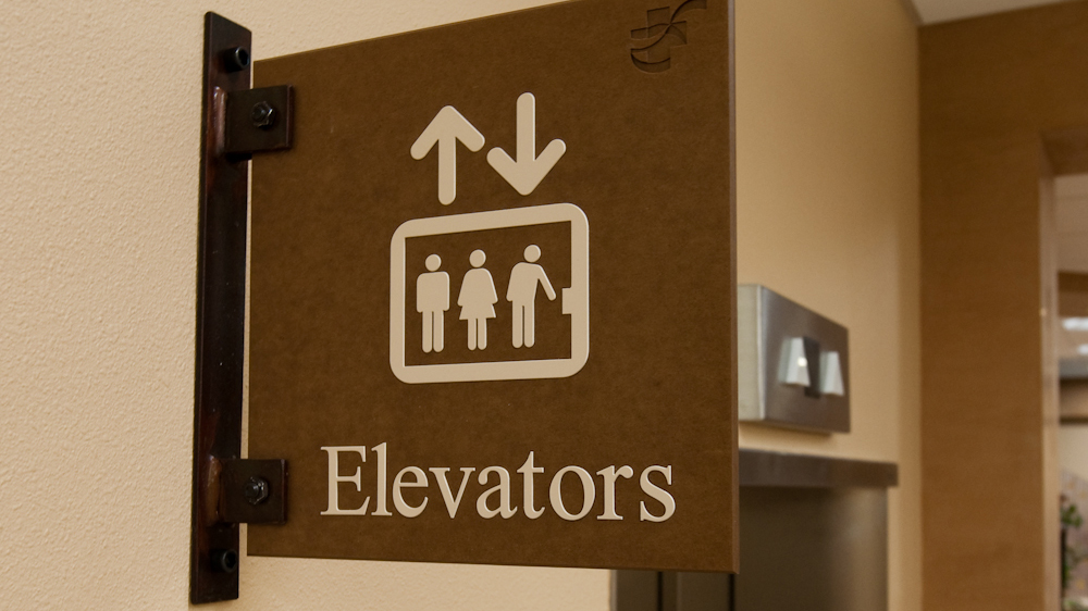 Projecting elevator identification sign from the CSB Texture Sign System