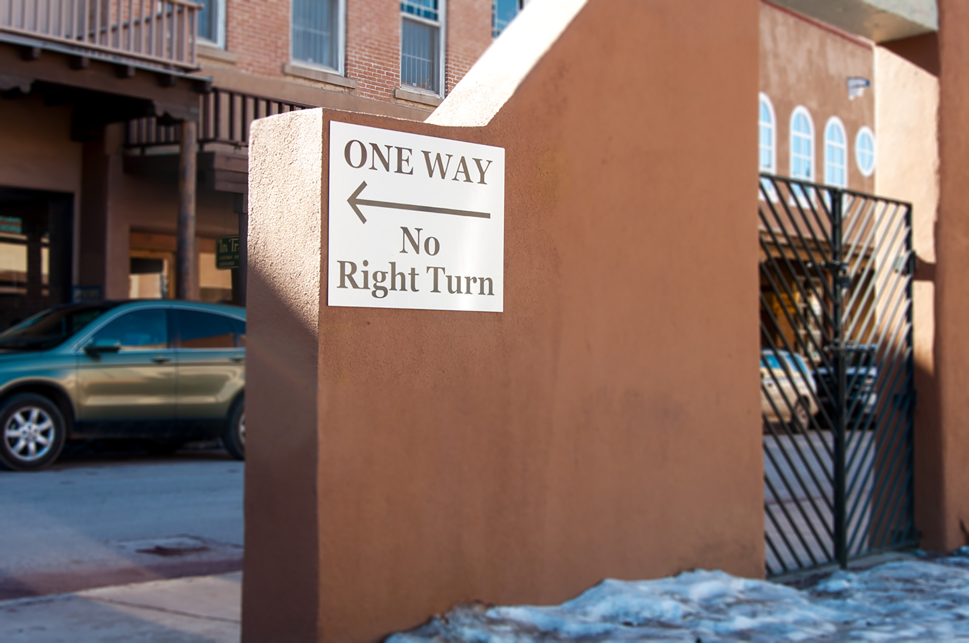 Bank parking only regulatory sign mounted on stucco wall at First National Bank Santa Fe