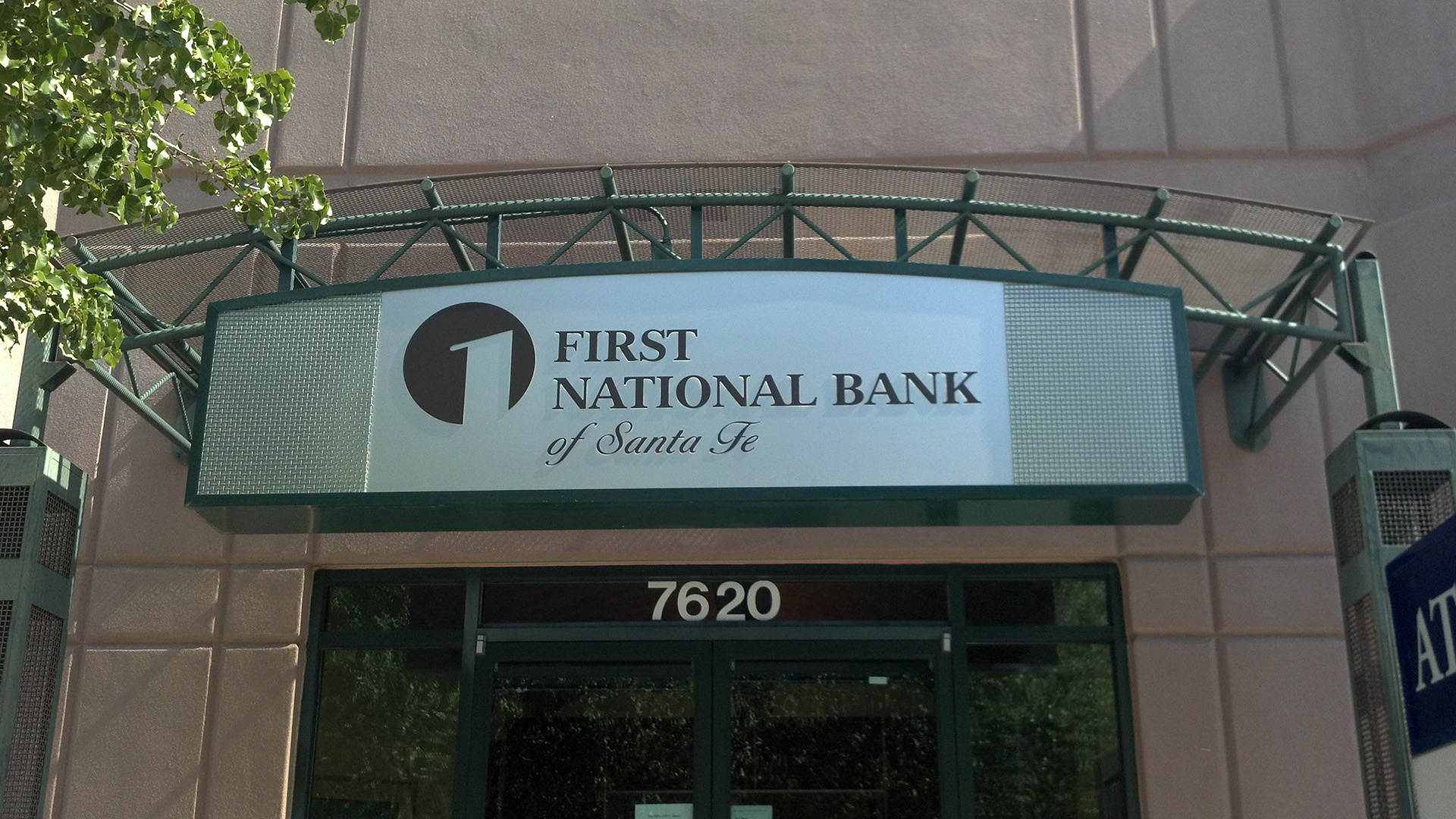 Wall mounted entry sign for First National Bank Santa Fe exterior entrance