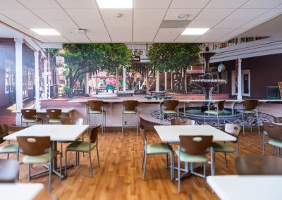 Large-format cafeteria supergraphic wall mural with Old Town Albuquerque imagery at Presbyterian Hospital