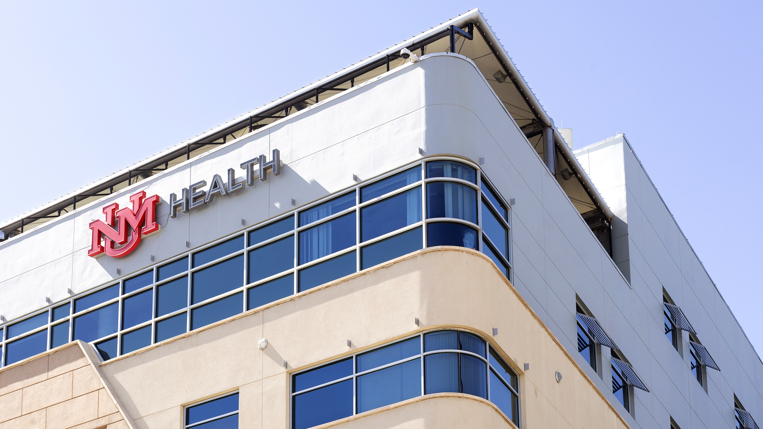 Exterior building identification signage for UNM Children's Hospital Pavilion with illuminated channel letters.
