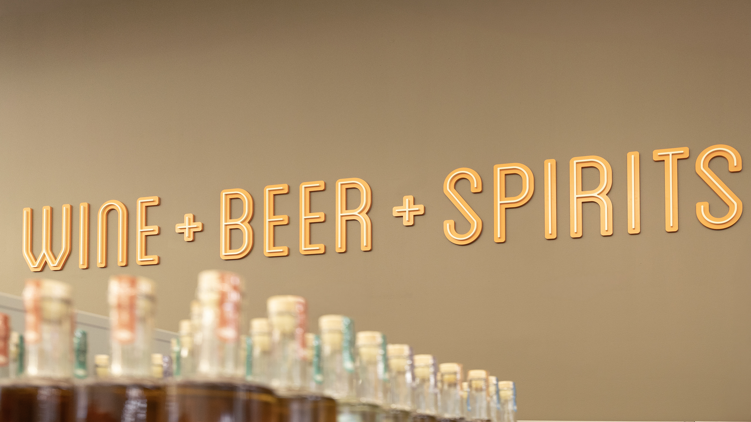 Wine Beer and Spirits Dimensional Letters Layered dimensional acrylic letters identifying wine beer and spirits department at La Montañita Food Co-op