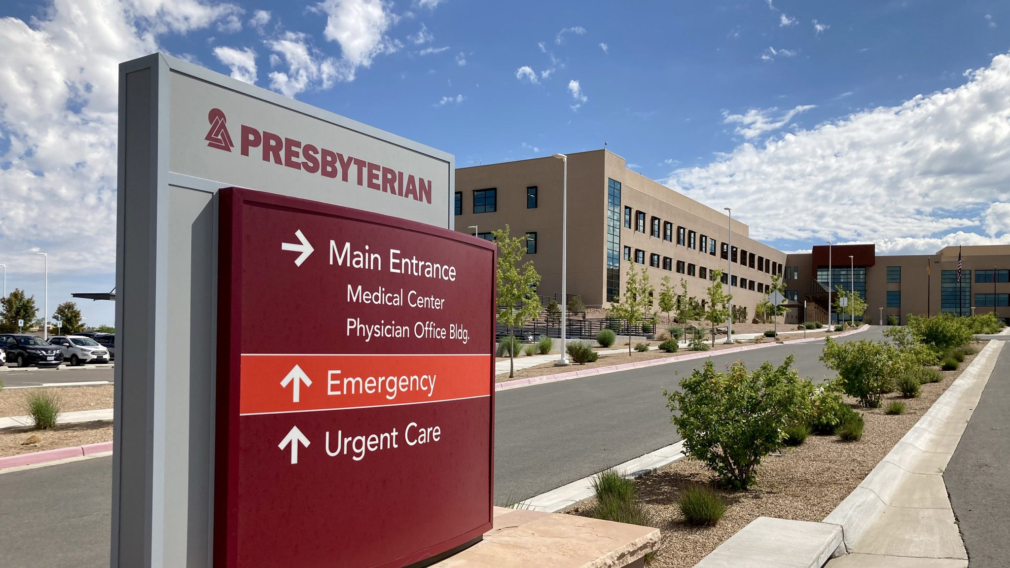 Exterior directional sign at Presbyterian Santa Fe Medical Center showing directions for main entrance, emergency, and urgent care.