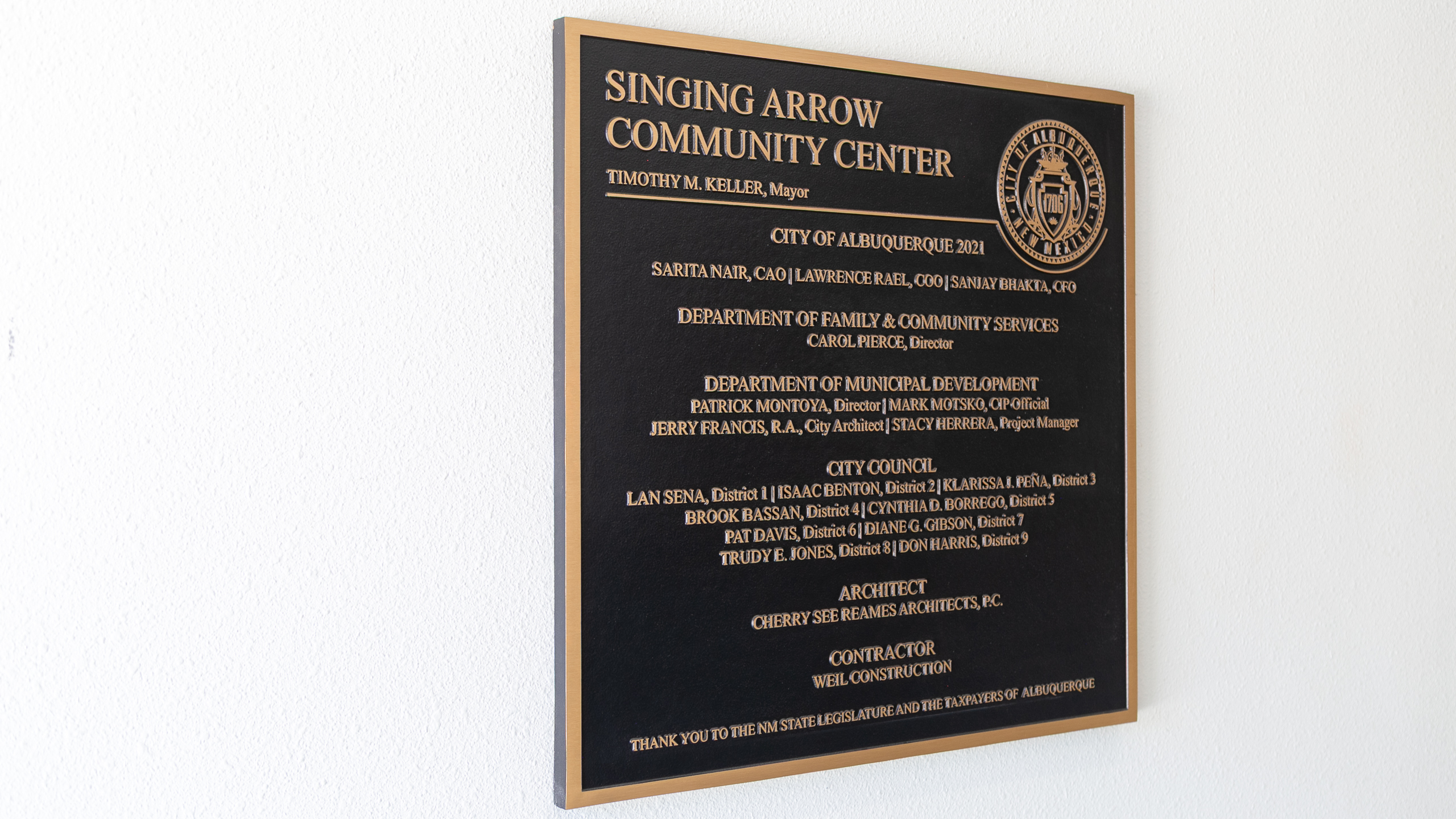 Angled view of the Singing Arrow Community Center cast bronze dedication plaque