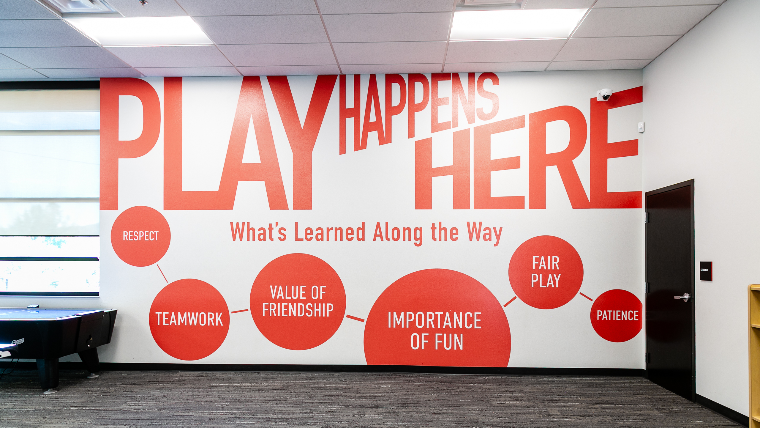 Full view of Play Happens Here vinyl wall supergraphics at Singing Arrow Community Center