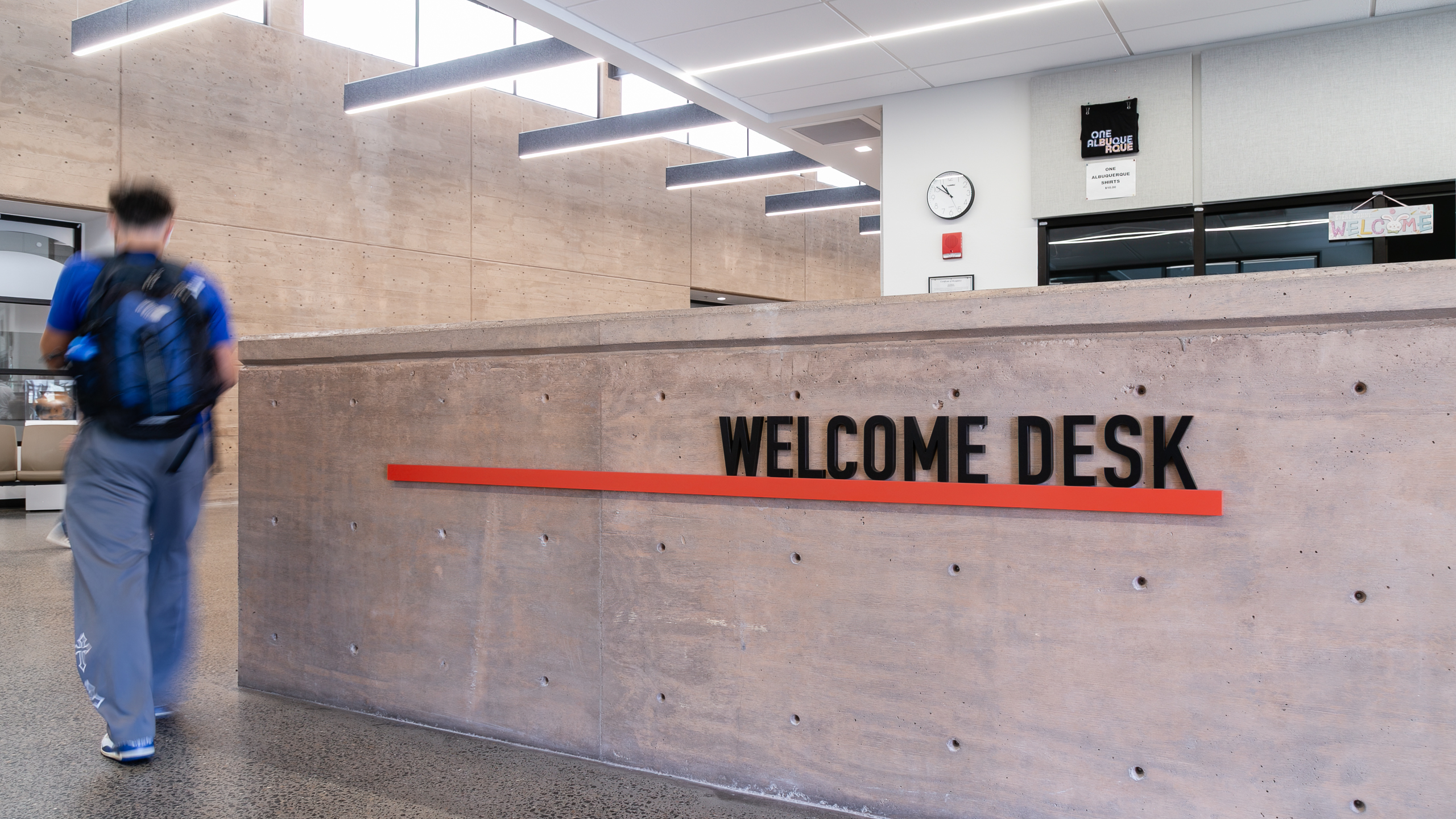 Angled view of Welcome Desk dimensional letters and orange accent rail
