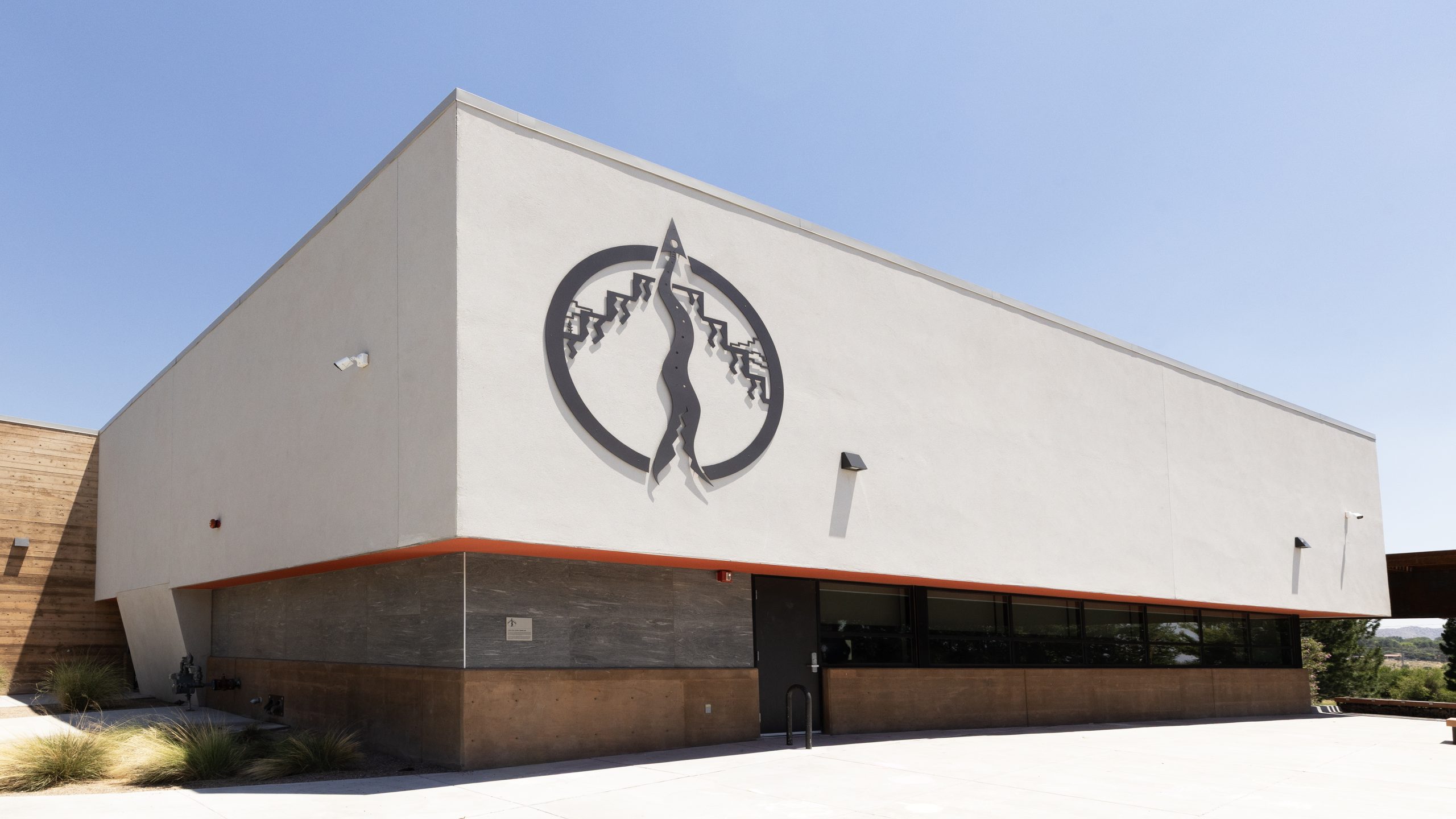 Singing Arrow Community Dimensional Flat Cut Aluminum Symbol mounted on exterior building